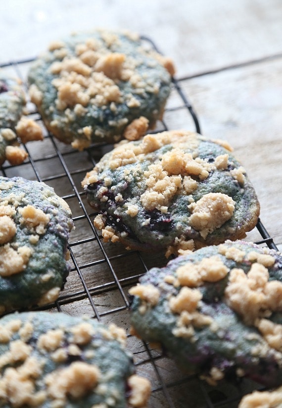 Soft blueberry cookies on a wire rack topped with streusel crumble.