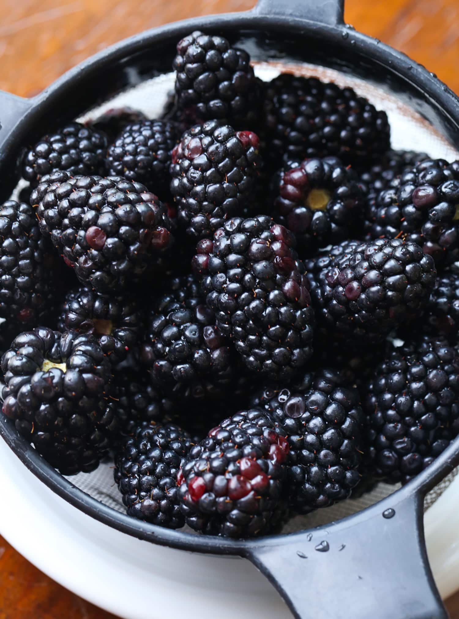 Blackberries in a strainer after being rinsed