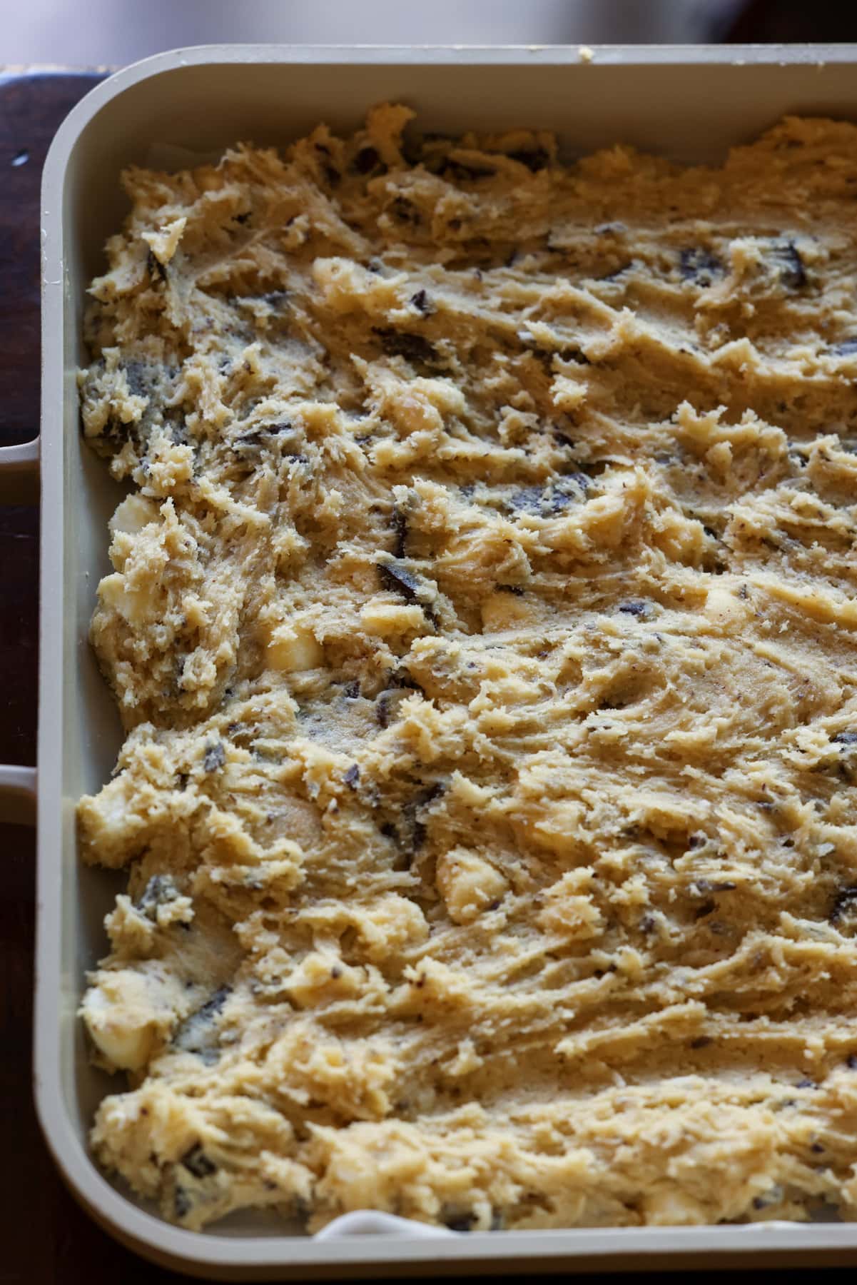 Blondie cookie dough pressed in a large baking dish