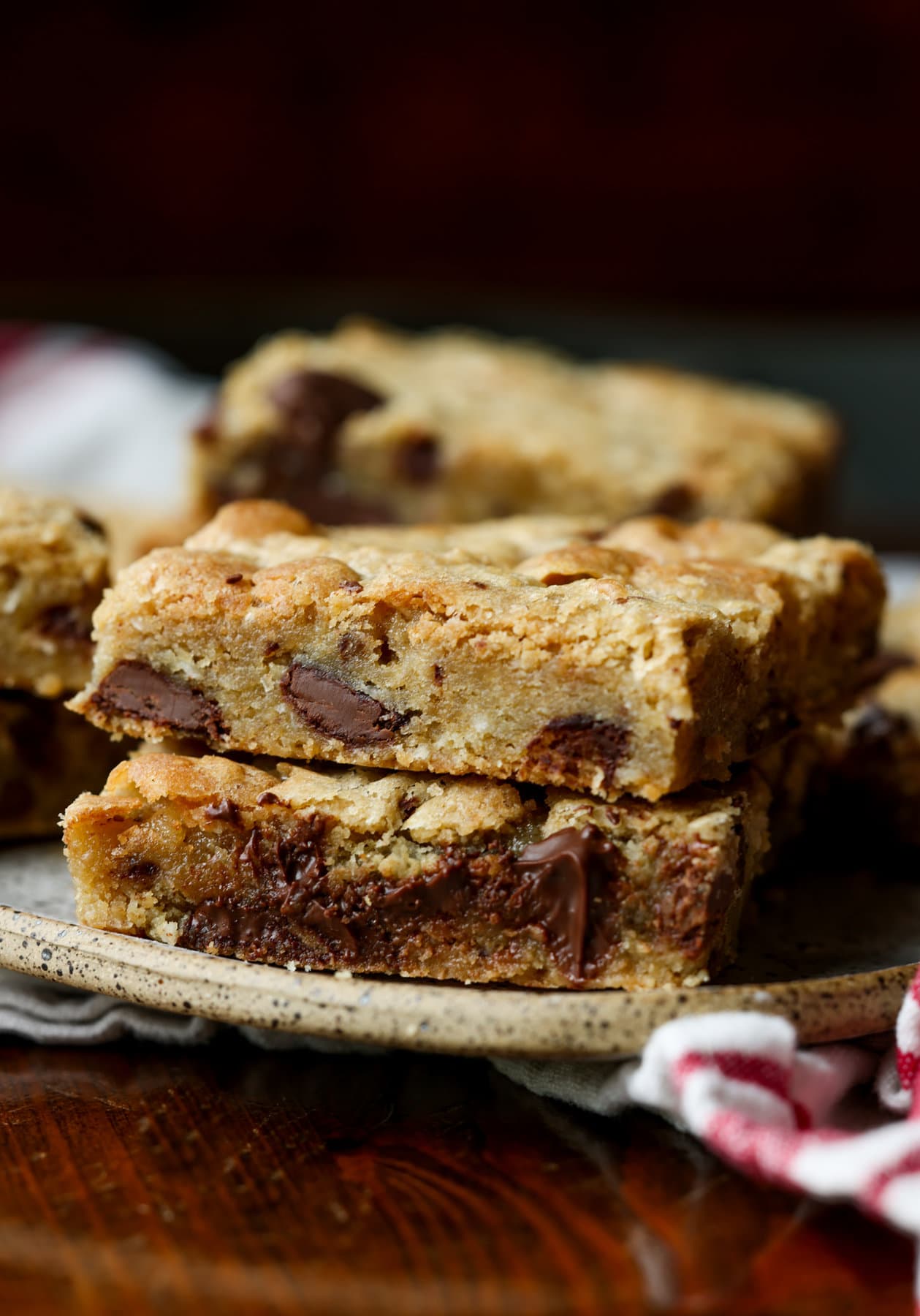 Two stacked blondies on a plate with chocolate chunks