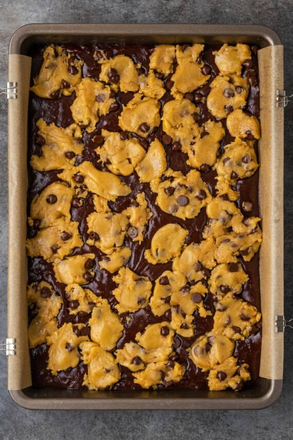 Unbaked brookies in a parchment-lined baking pan.
