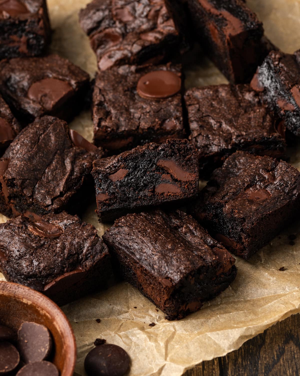 Assorted fudgy cake mix brownies filled with chocolate chunks on a sheet of parchment paper.