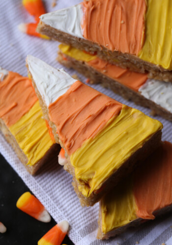 Candy Corn Scotcheroos decorated with colored candy melts, stacked on top of one another.