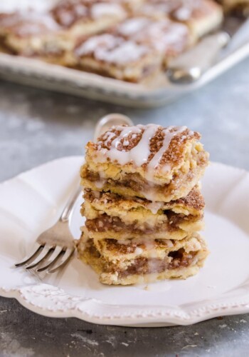 A stack of apple pie bars on a plate.