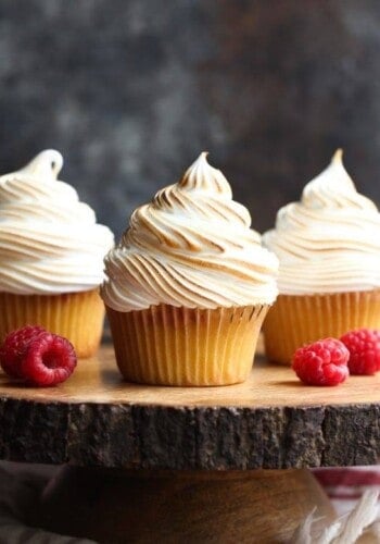 Vanilla cupcakes with toasted frosting and raspberries