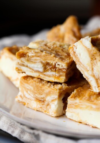 Dulce de Leche Swirled Vanilla Fudge squares stacked on a plate.