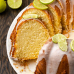 Key lime pound cake cut into slices, garnished with fresh limes.