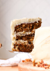 lifting a piece of carrot cake off of a cake plate