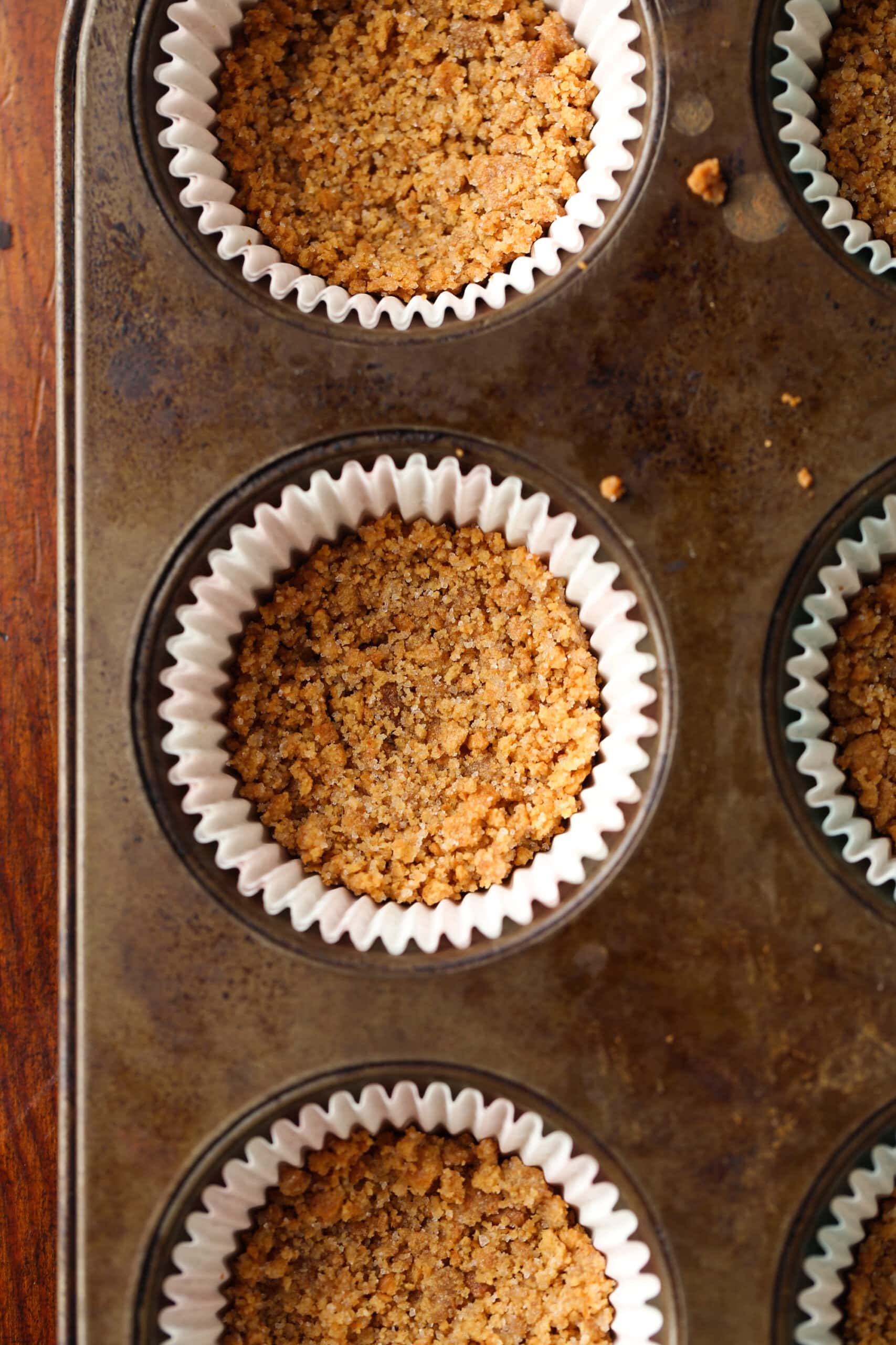 graham cracker crust in cupcake liner baked in a muffin tin