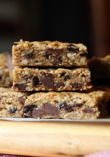stacked oatmeal cookie bars with chocolate chips, raisins, and walnuts