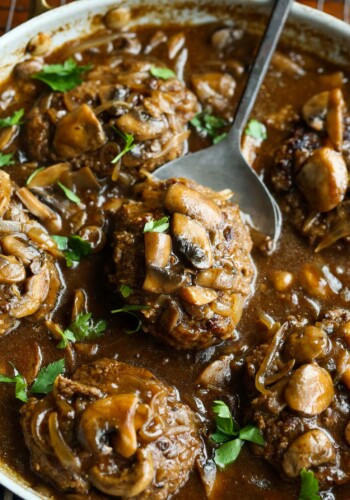 Easy Salisbury Steak recipe in a skillet with brown gravy, onions and mushrooms