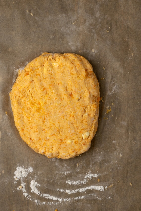 Kneaded sweet potato biscuit dough pressed into a flat disc.